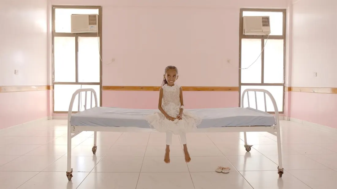 A young girl on a hospital bed in Hunger Ward