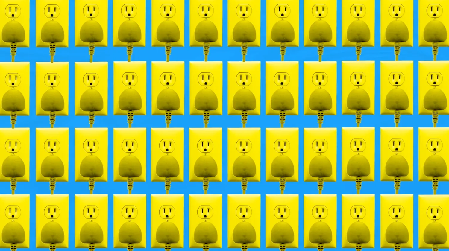 Bright yellow electrical plugs against a blue background